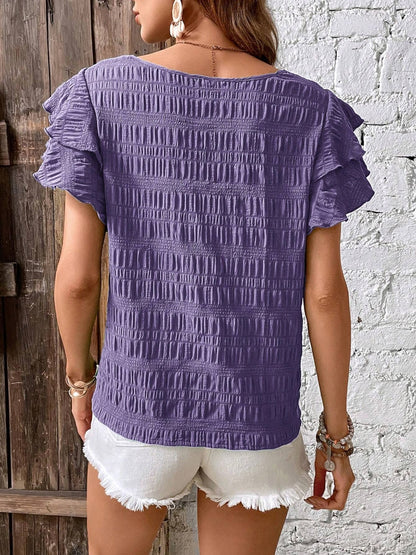 Blusa con cuello redondo y mangas con volantes