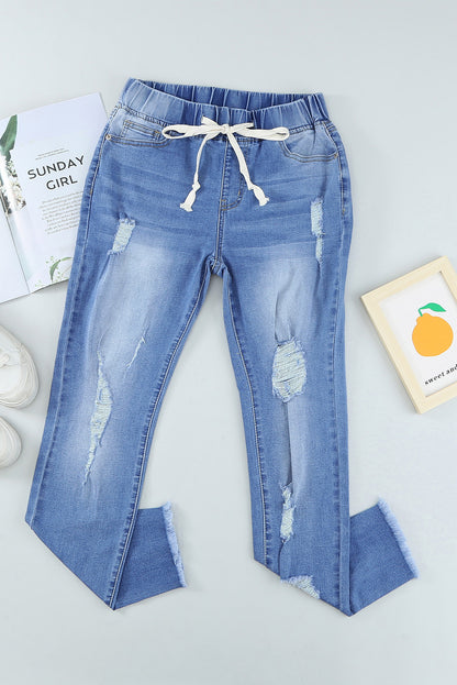 Distressed-Jeans mit Kordelzug, offenem Saum und Taschen
