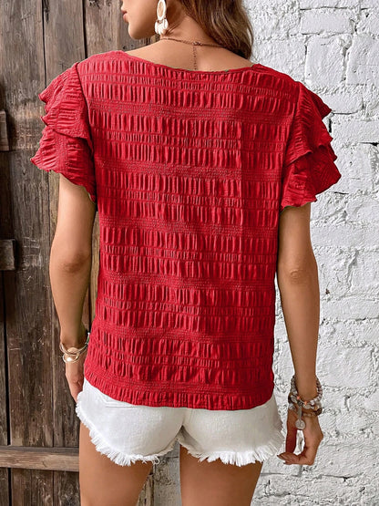 Blusa con cuello redondo y mangas con volantes