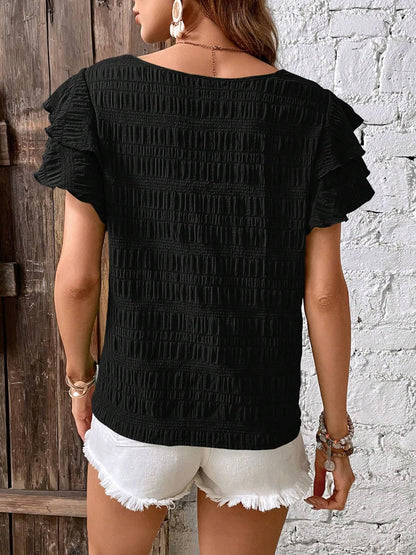 Blusa con cuello redondo y mangas con volantes