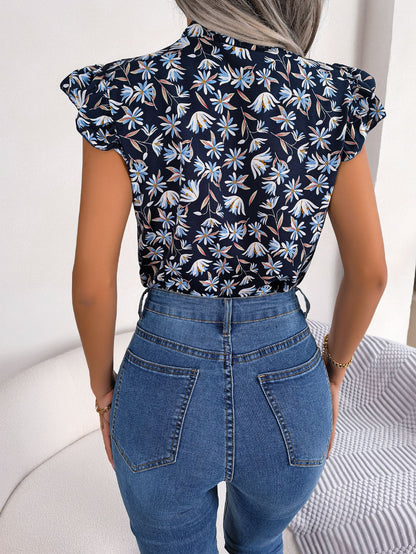 Blusa con mangas abullonadas y cuello con lazo floral