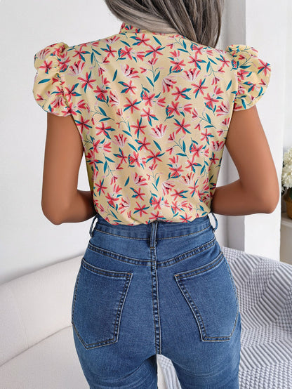 Blusa con mangas abullonadas y cuello con lazo floral